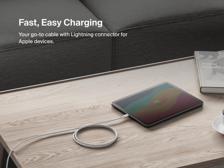 Belkin BoostCharge Pro USB-C Braided Cable with Lightning Connector shown charging an iPad on a coffee table, offering fast, reliable power for Apple devices.