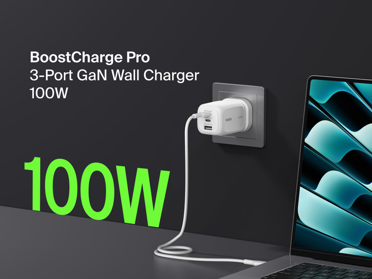 BoostCharge Pro 3-Port GaN Wall Charger 100W plugged into a wall outlet, fast charging a laptop with bold green “100W” text highlighting its powerful output.