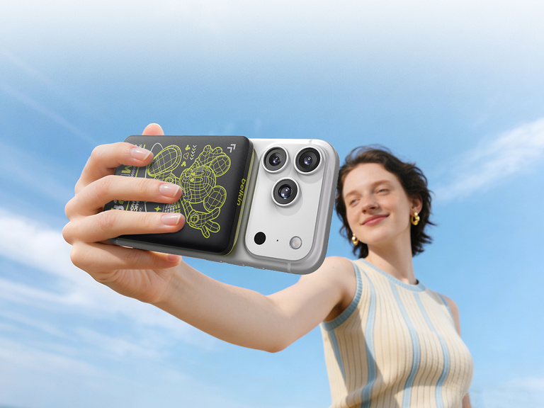 Belkin BoostCharge Slim Magnetic Power Bank 5K shown aligning with a smartphone and MagSafe-compatible case, demonstrating wireless charging through cases up to 3mm thick.