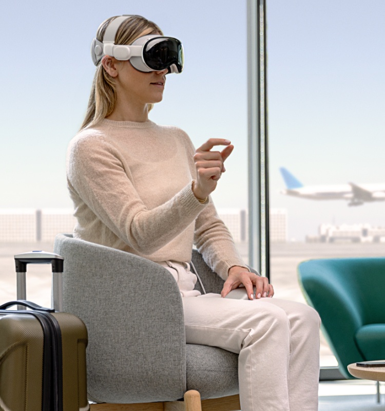 Eine Person am Flughafen, die die Apple Vision Pro mit dem Kopfgurt aufgesetzt hat.