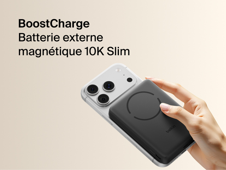 Belkin BoostCharge Slim Magnetic Power Bank 10K magnetically attached to iPhone showing slim portable design for wireless charging