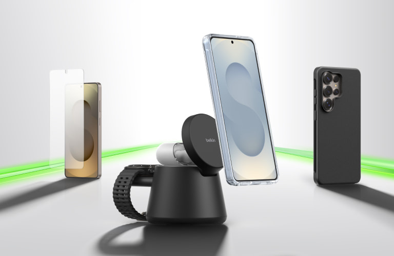 Samsung phone ecosystem displayed on a clean surface, featuring a smartphone with a screen protector, a magnetic wireless charging stand, earbuds, and a protective case, connected by a glowing green line to suggest seamless compatibility.