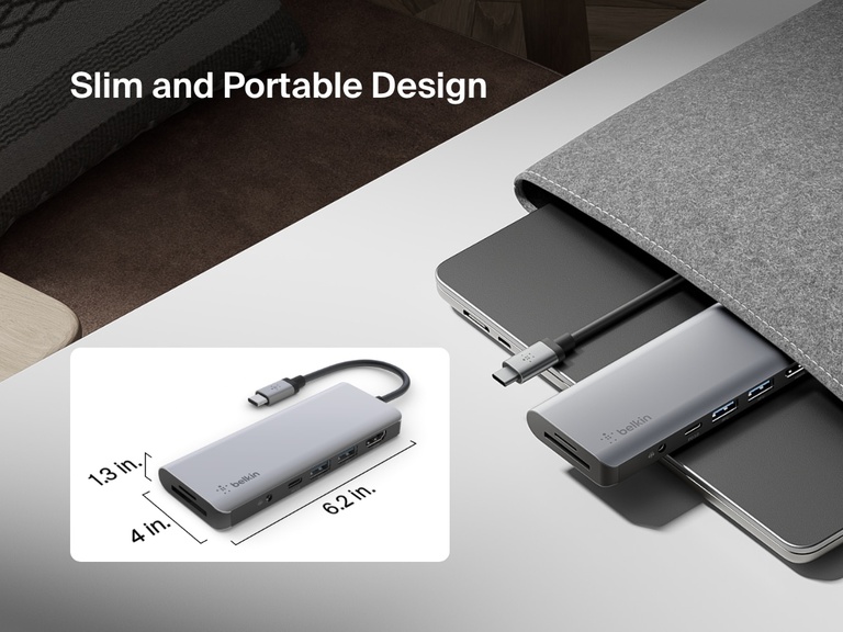 Image showing the slim and portable design of the Belkin Connect USB-C 7-in-1 Multiport Hub, partially tucked into a laptop sleeve with dimensions labeled and an 8.27-inch cord.
