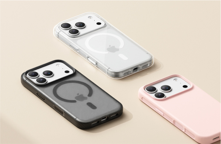 Three iPhones in protective MagSafe-compatible cases displayed on a beige background in clear, black, and pink colors. Three iPhones in protective MagSafe-compatible cases displayed on a beige background in clear, black, and pink colors.
