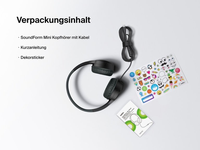 Flat lay image showing the contents of the Belkin SoundForm Mini Wired Headphones box, including the headphones, a quick start guide, and a sheet of decorative stickers.