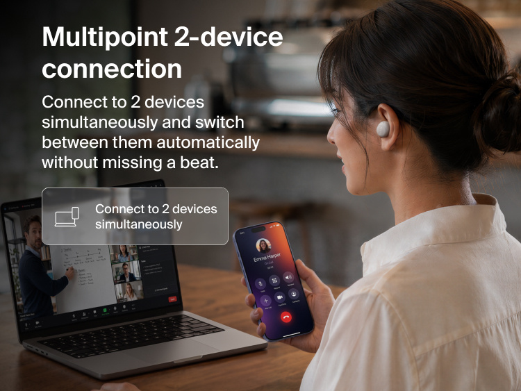 Person wearing a SoundForm Dot ANC Noise-Cancelling Earbud at a table while switching audio between a laptop video call and a smartphone, demonstrating multipoint 2-device connection