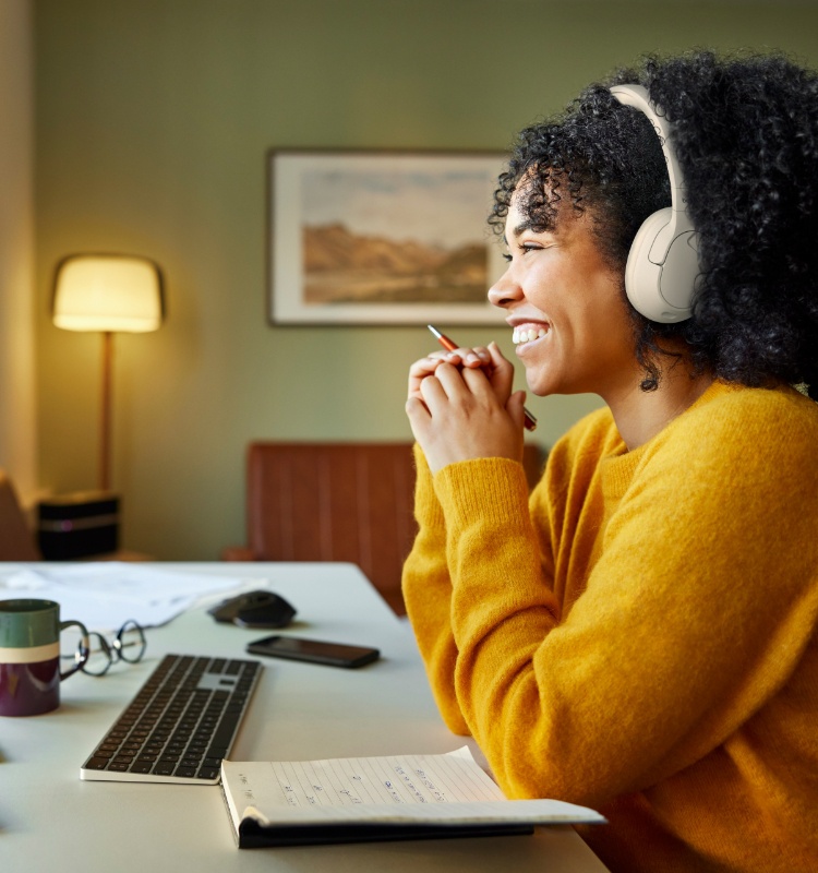 A person is wearing Noise-Cancelling Over-Ear Headphones while participating in a virtual meeting.