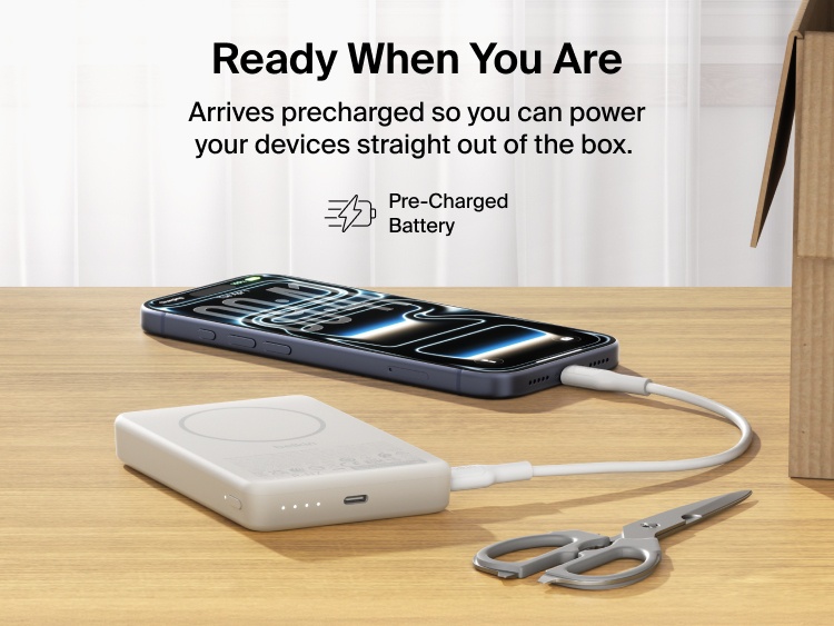 Belkin BoostCharge Slim Magnetic Power Bank 10K precharged out of the box powering a smartphone via USB-C cable with portable battery placed on a desk