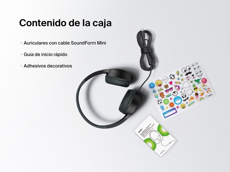 Flat lay image showing the contents of the Belkin SoundForm Mini Wired Headphones box, including the headphones, a quick start guide, and a sheet of decorative stickers.