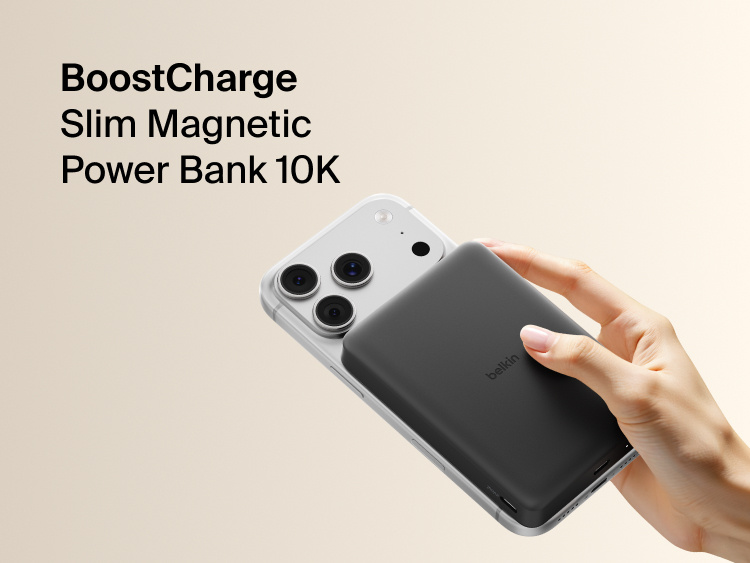 Belkin BoostCharge Slim Magnetic Power Bank 10K magnetically attached to iPhone, demonstrating secure wireless charging with a slim portable design