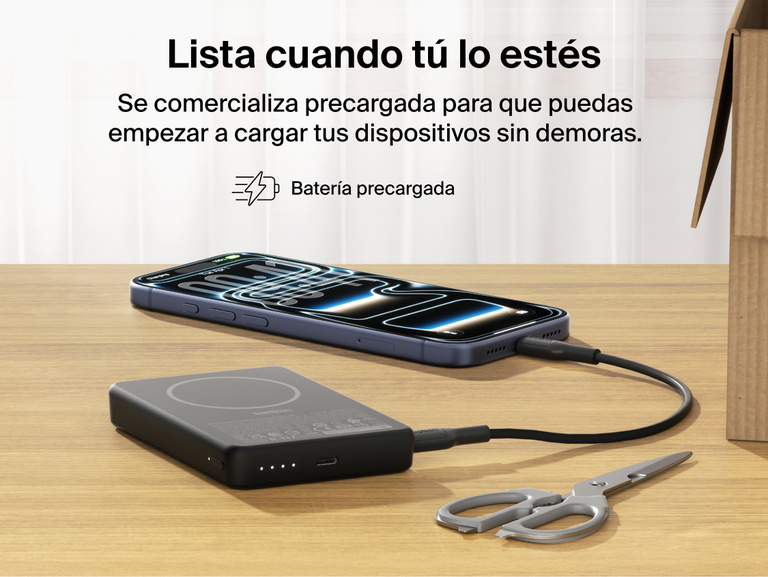 Belkin BoostCharge Slim Magnetic Power Bank 10K precharged out of the box powering a smartphone via USB-C cable with portable battery placed on a desk
