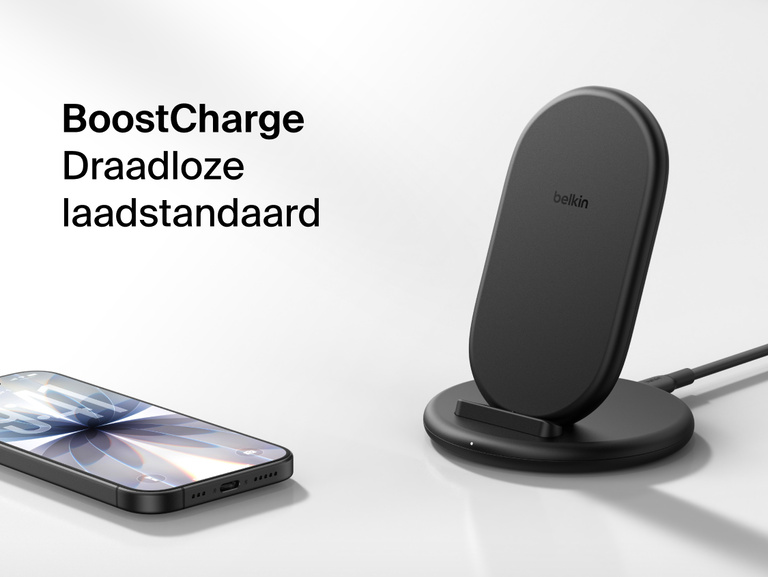 Belkin BoostCharge Wireless Charging Stand 15W shown with smartphone nearby, featuring a sleek upright design for fast wireless charging.