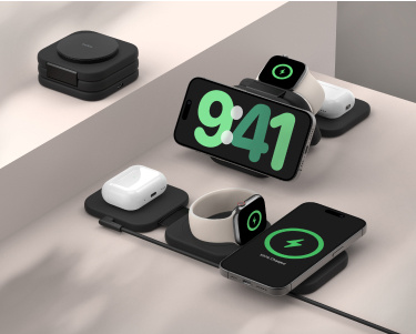 This image showcases a sleek, modular charging station designed to wirelessly charge multiple devices simultaneously. The setup includes slots for a smartphone, wireless earbuds, and a smartwatch, all shown actively charging. A compact folded version of the charging station is visible in the background, emphasizing portability. The devices are neatly arranged, highlighting the product's efficiency and modern design. This image showcases a sleek, modular charging station designed to wirelessly charge multiple devices simultaneously. The setup includes slots for a smartphone, wireless earbuds, and a smartwatch, all shown actively charging. A compact folded version of the charging station is visible in the background, emphasizing portability. The devices are neatly arranged, highlighting the product's efficiency and modern design.