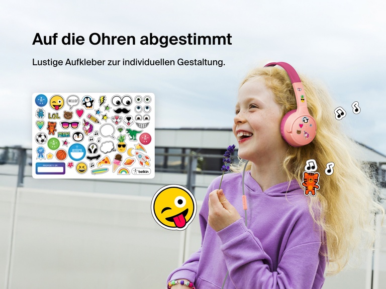 Smiling girl wearing Belkin Wired On-Ear Headphones for Kids decorated with colorful stickers, highlighting the headset’s personalization feature with included fun sticker sheet.