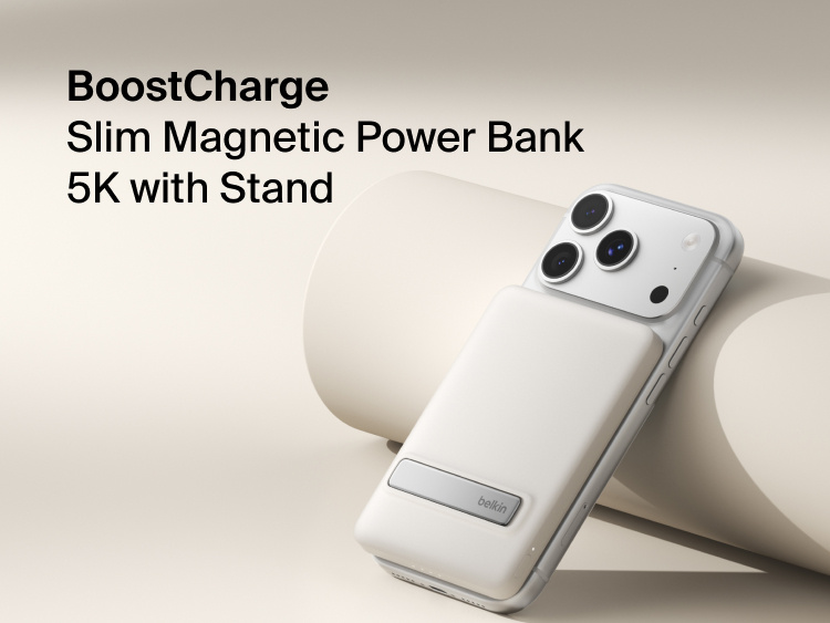 Belkin BoostCharge Slim Magnetic Power Bank 5K with Qi2 wirelessly attached to a smartphone, featuring a slim magnetic design with integrated card storage for portable on-the-go charging.