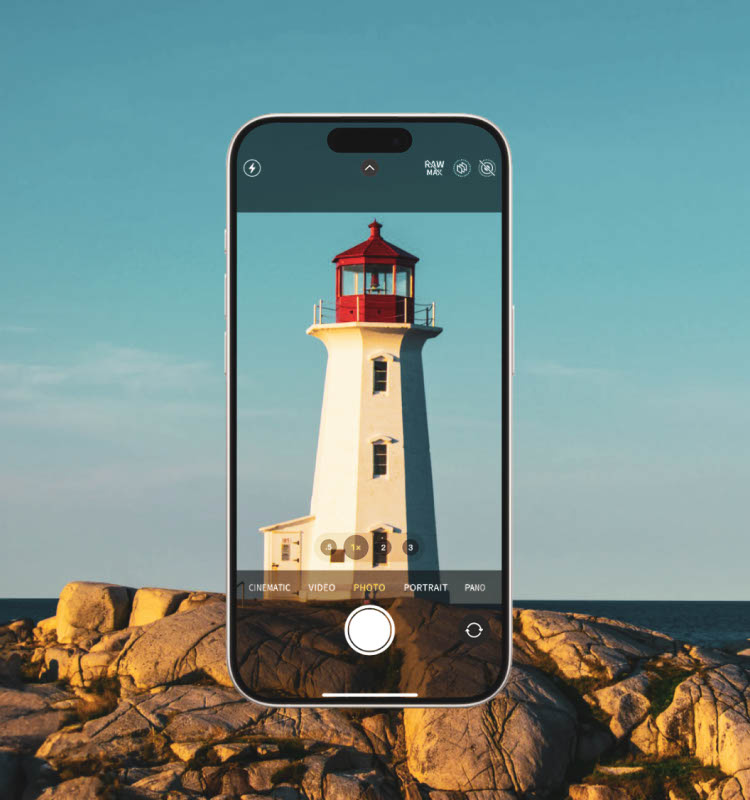 An iPhone displaying a lighthouse on its screen in photo mode, with the surrounding scene of the lighthouse and rocky landscape visible in the background, showcasing the clarity provided by the ScreenForce TemperedGlass Camera Lens Protector.