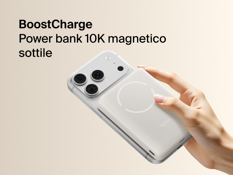 Belkin BoostCharge Slim Magnetic Power Bank 10K magnetically attached to iPhone showing slim portable design for wireless charging