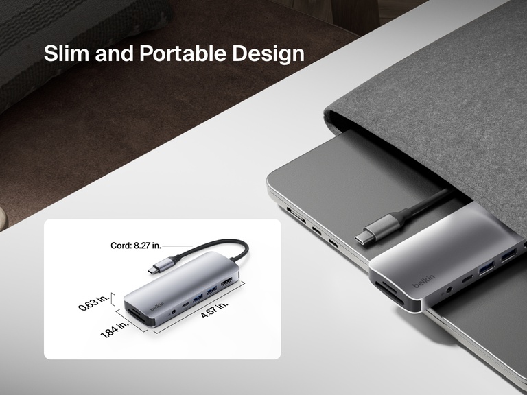Image showing the slim and portable design of the Belkin Connect USB-C 7-in-1 Multiport Hub, partially tucked into a laptop sleeve with dimensions labeled and an 8.27-inch cord.
