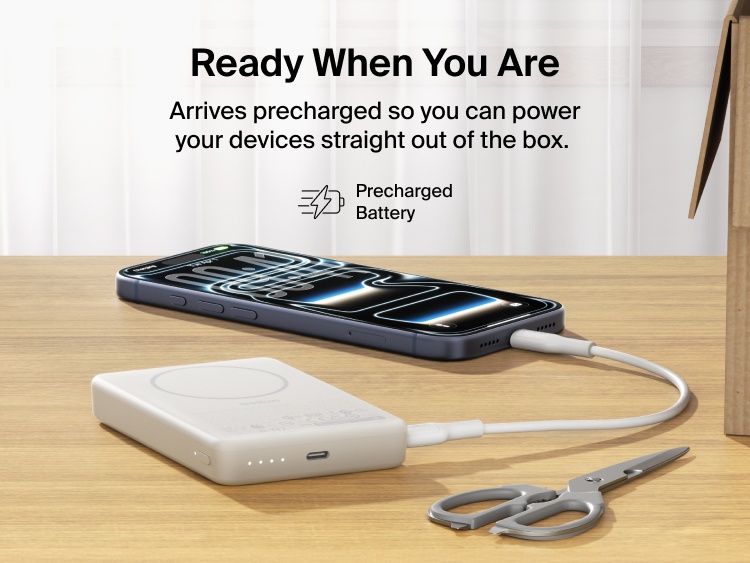 Slim Magnetic Power Bank 10K with Qi2 charging smartphone on desk with LED battery indicators and precharged readiness
