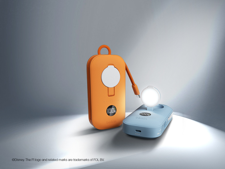 Belkin BoostCharge Slim Magnetic Power Bank 5K shown magnetically attached to a smartphone beside a slim wallet accessory, highlighting its compact portable charging design.