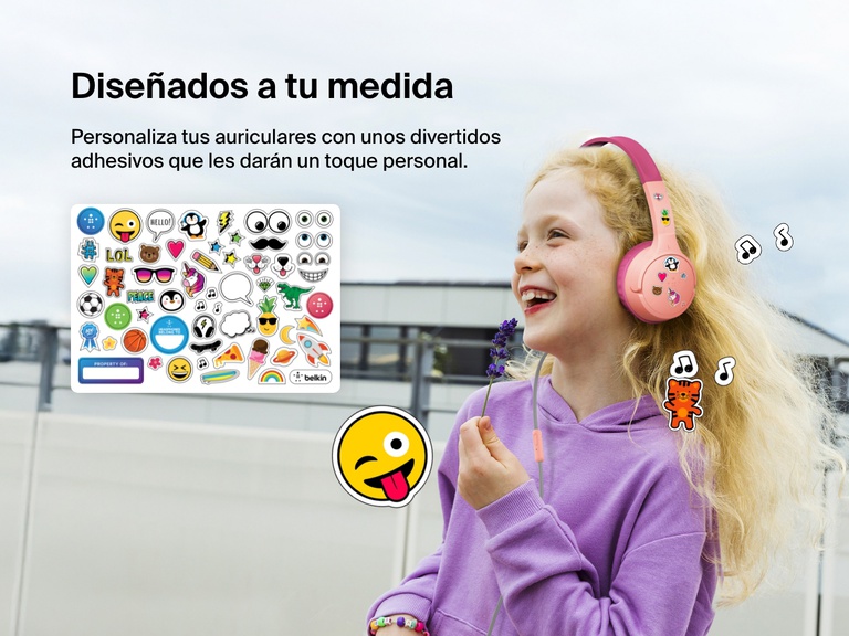 Smiling girl wearing Belkin Wired On-Ear Headphones for Kids decorated with colorful stickers, highlighting the headset’s personalization feature with included fun sticker sheet.