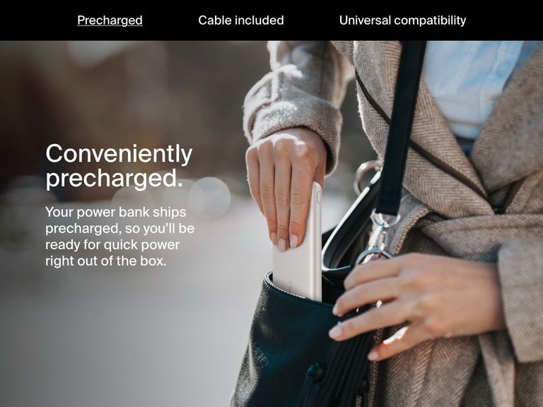A woman places a white Belkin BoostCharge Power Bank 10K into her handbag, highlighting its precharged convenience for immediate use right out of the box.