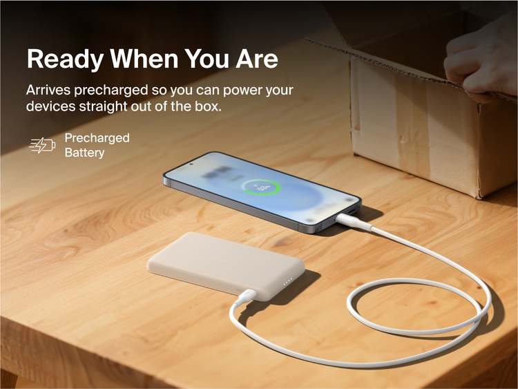Belkin BoostCharge Slim Magnetic Power Bank 5K shown charging a smartphone on a table, highlighting its precharged battery ready for instant use out of the box.