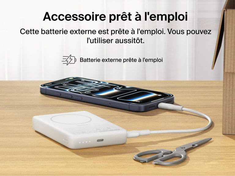 Belkin BoostCharge Slim Magnetic Power Bank 10K precharged out of the box powering a smartphone via USB-C cable with portable battery placed on a desk
