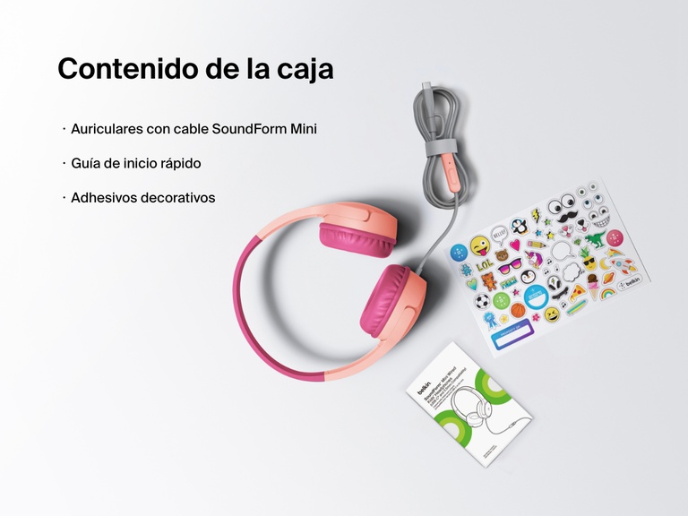 Flat lay image showing the contents of the Belkin SoundForm Mini Wired Headphones box, including the headphones, a quick start guide, and a sheet of decorative stickers.