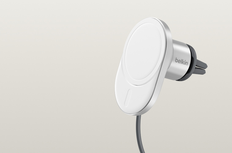 BoostCharge Pro Magnetic Wireless Car Charger with Qi2 15W shown in white, featuring a sleek circular charging pad, integrated cable, and a car vent mount attachment against a neutral background.