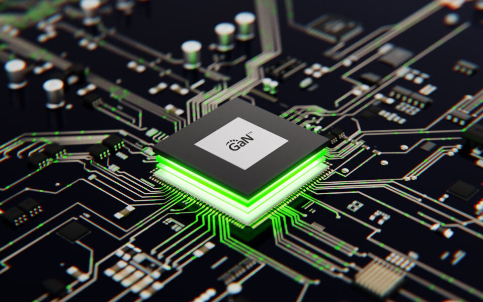 A close-up digital rendering of a GaN (Gallium Nitride) semiconductor chip on a circuit board, glowing with green light. The intricate circuitry highlights the advanced technology used in GaN-based electronic components for efficient power delivery and high-performance computing.