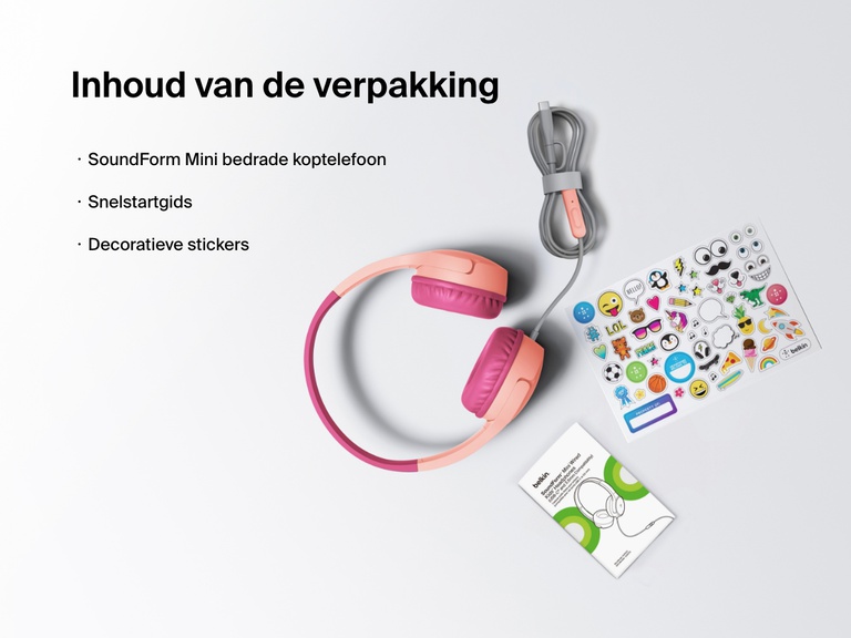 Flat lay image showing the contents of the Belkin SoundForm Mini Wired Headphones box, including the headphones, a quick start guide, and a sheet of decorative stickers.