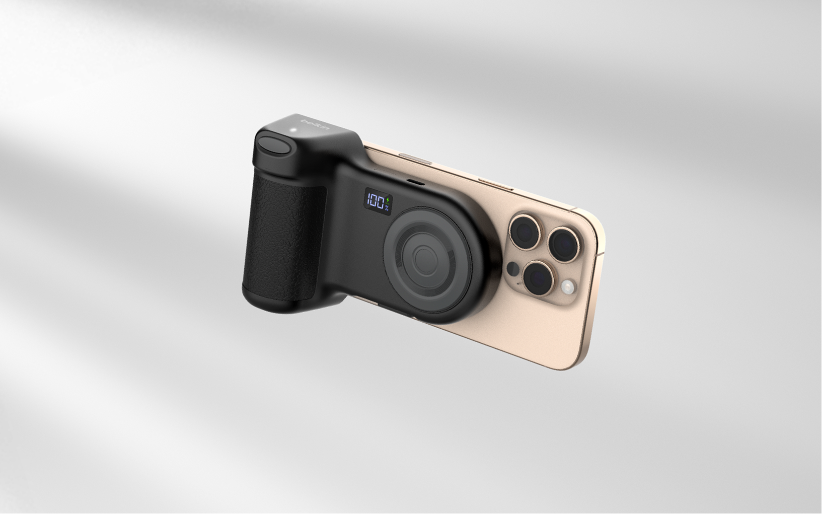 Smartphone attached to a black Belkin camera grip accessory with a digital battery indicator, designed to enhance mobile photography control and stability.