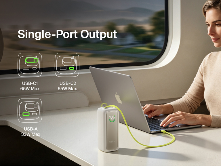 UltraCharge Power Bank 22K with Retractable Cable charging a laptop from a single port on a train tray table, with icons showing USB-C1, USB-C2, and USB-A single-port output wattages