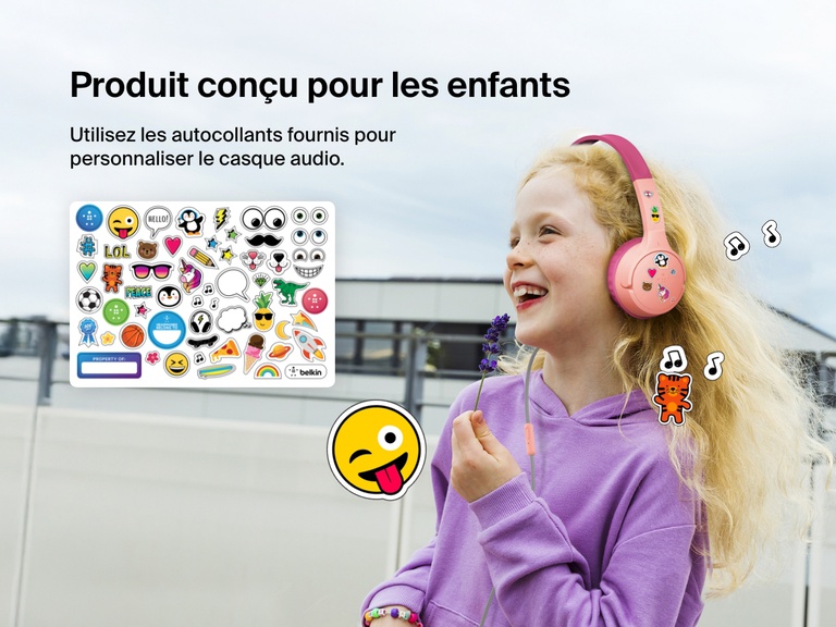 Smiling girl wearing Belkin Wired On-Ear Headphones for Kids decorated with colorful stickers, highlighting the headset’s personalization feature with included fun sticker sheet.
