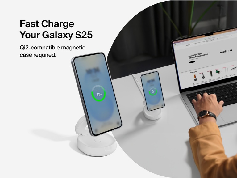 Belkin BoostCharge 2-in-1 Convertible Magnetic Charging Stand with Qi2 15W shown fast charging a Galaxy S25 in a Qi2-compatible magnetic case at a desktop workspace.