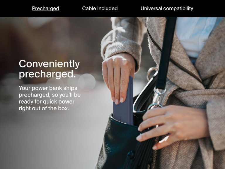 A woman places a blue Belkin BoostCharge Power Bank 10K into her handbag, highlighting its precharged convenience for immediate use right out of the box.