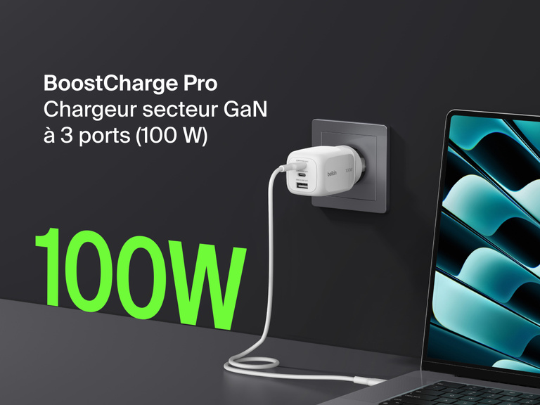 BoostCharge Pro 3-Port GaN Wall Charger 100W plugged into a wall outlet, fast charging a laptop with bold green “100W” text highlighting its powerful output.