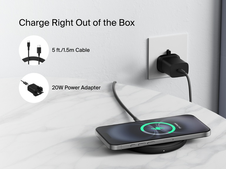 A black Belkin BoostCharge Wireless Charging Pad 15W is shown on a marble surface charging a smartphone, with text highlighting that it includes a 5 ft. (1.5m) cable and a 20W power adapter for easy setup right out of the box.