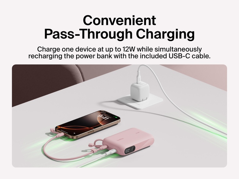 Belkin BoostCharge Power Bank 10K with Display shown delivering pass-through charging, powering a smartphone at up to 12W while recharging via the included USB-C cable.