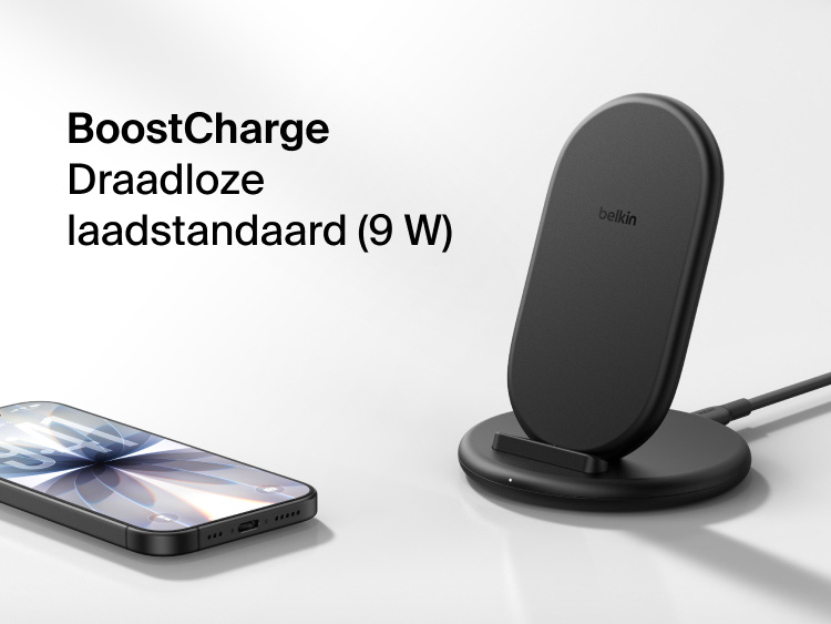 Belkin BoostCharge Wireless Charging Stand 15W shown with smartphone nearby, featuring a sleek upright design for fast wireless charging.