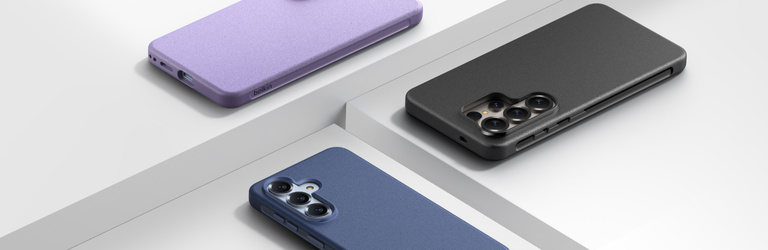 Three Samsung smartphones displayed face down in purple, black, and blue protective cases, arranged on a clean white platform background to showcase different case color options.