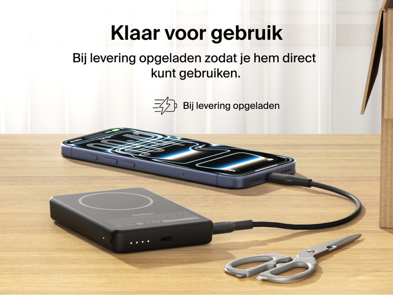 Slim Magnetic Power Bank 10K with Qi2 charging smartphone on desk with precharged battery indicator lights visible