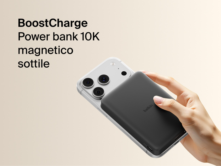 Belkin BoostCharge Slim Magnetic Power Bank 10K magnetically attached to iPhone, demonstrating secure wireless charging with a slim portable design