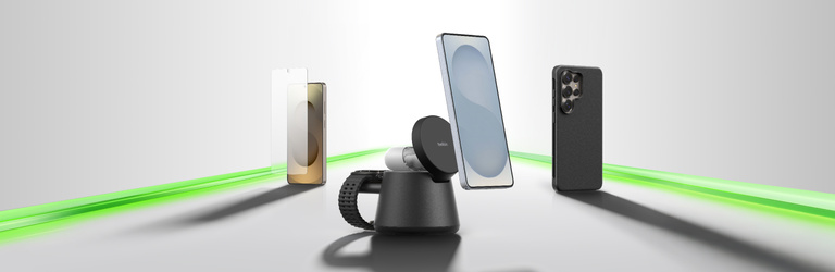 Samsung Galaxy phone accessories displayed on a clean background, including a magnetic wireless charging stand with phone attached, a clear case, and a black protective case, highlighted by a green light streak representing ecosystem connectivity.