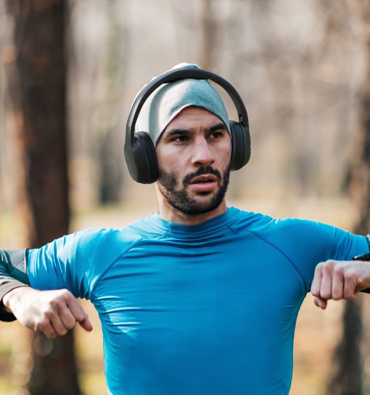 A person wearing Noise-Cancelling Over-Ear Headphones while working out.