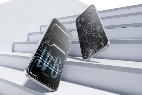 Two smartphones falling on stairs, one with an intact screen protected by tempered glass and the other with a cracked screen. Two smartphones falling on stairs, one with an intact screen protected by tempered glass and the other with a cracked screen.