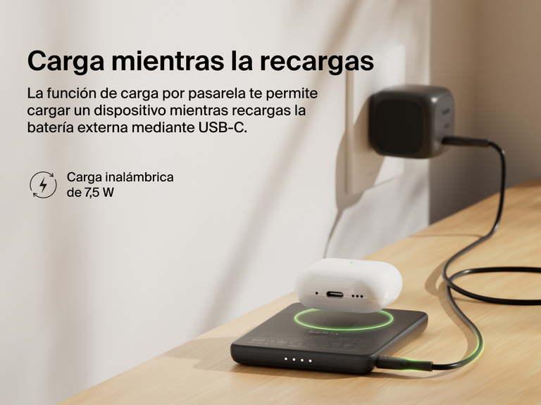 Belkin BoostCharge Slim Magnetic Power Bank 5K shown wirelessly charging earbuds while recharging via USB-C, demonstrating 7.5W pass-through charging functionality.
