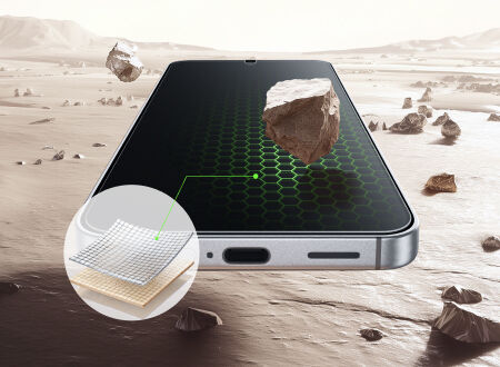 Smartphone lying on a rocky, desert-like surface with stones hovering above the screen, alongside an inset showing layered screen protector material to suggest impact resistance.