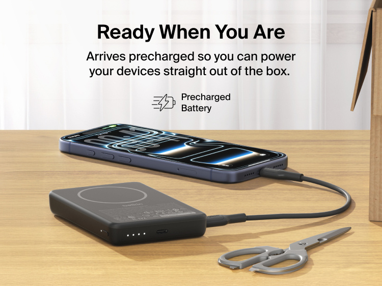 Slim Magnetic Power Bank 10K with Qi2 charging smartphone on desk with LED battery indicators and precharged readiness